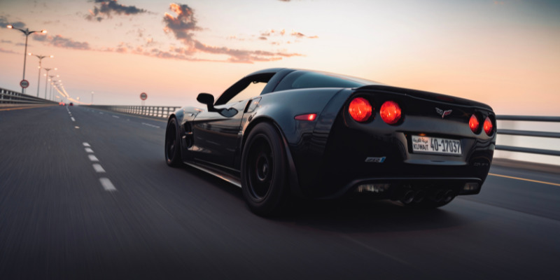 Corvette driving toward the sunset